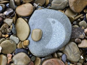rock on beach with moon shape